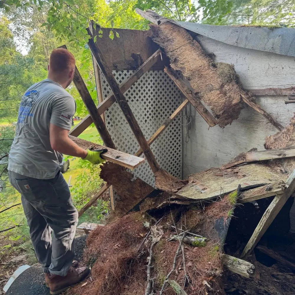 Hands-on debris removal in a photo from the original JF Property Services About page