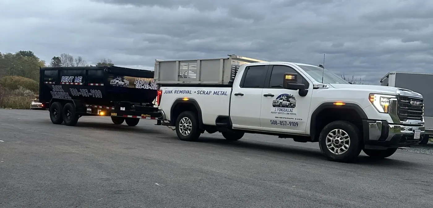 JF Property Services white pickup truck towing a black dumpster trailer
